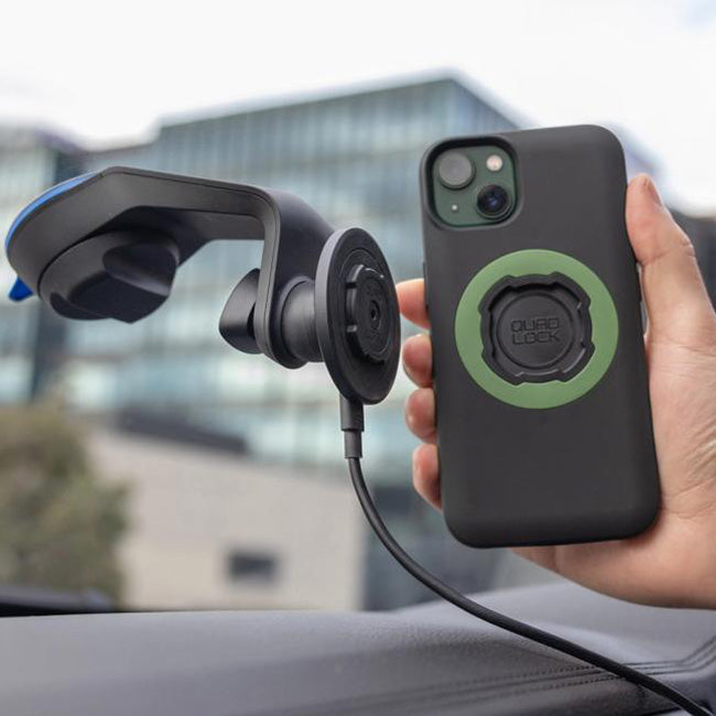 Phone holder with car mount and phone case on a blurred outdoor background